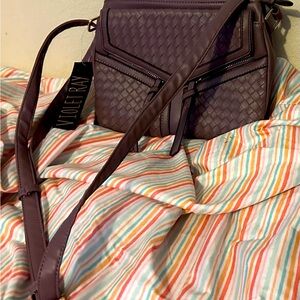 NWT Violet Ray purse with many pockets and dividers. Close with a magnetic snap